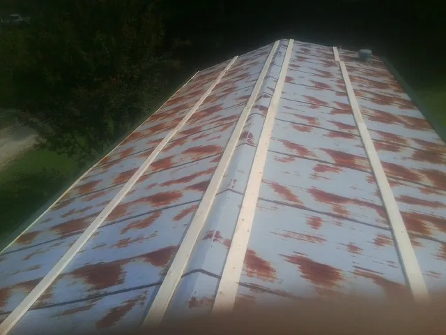 Rusted metal roof panels with new wood purlins before replacement — Storm Damage Roof Repair in Orofino by Roofing Brothers